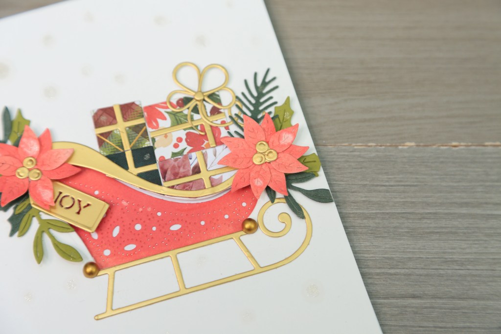 Spellbinders Delivering Joy sleigh die used with traditional holiday colours for card making
