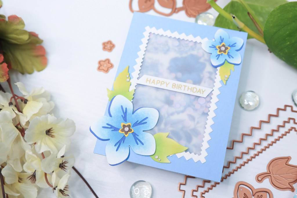 Spellbinders pinking edges dies used to create a vellum shaker card with florals from essential envelope dies by Spellbinders