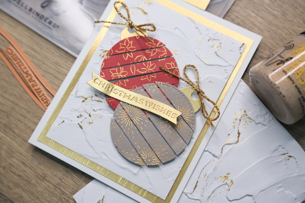 Cute DIY Christmas card decorated with Christmas Ornaments made using pattern paper.