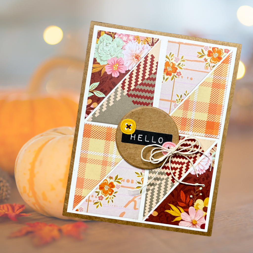 A handmade greeting card featuring a patchwork design of various patterned papers in autumn colors, accented with a circular tag that says 'HELLO' and a decorative twine bow.