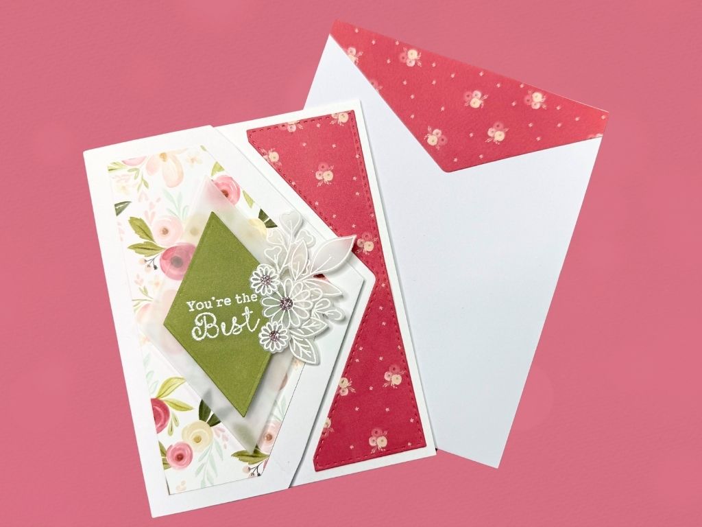 A beautifully asymmetrical fold card featuring floral-patterned paper, a decorative green diamond with the text 'You're the Best,' and an embellished envelope with a pink floral lining.