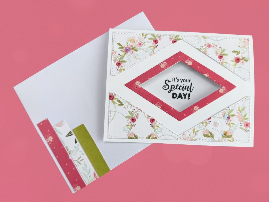 A diamond-shaped aperture card with decorative floral patterns, featuring the sentiment 'It's your Special DAY!' inside the window. A matching envelope with colorful patterned strips is positioned beside the card.
