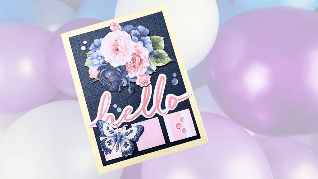 A handmade greeting card featuring floral designs, the word 'hello' in a playful font, and decorative elements, set against a background of colorful balloons.