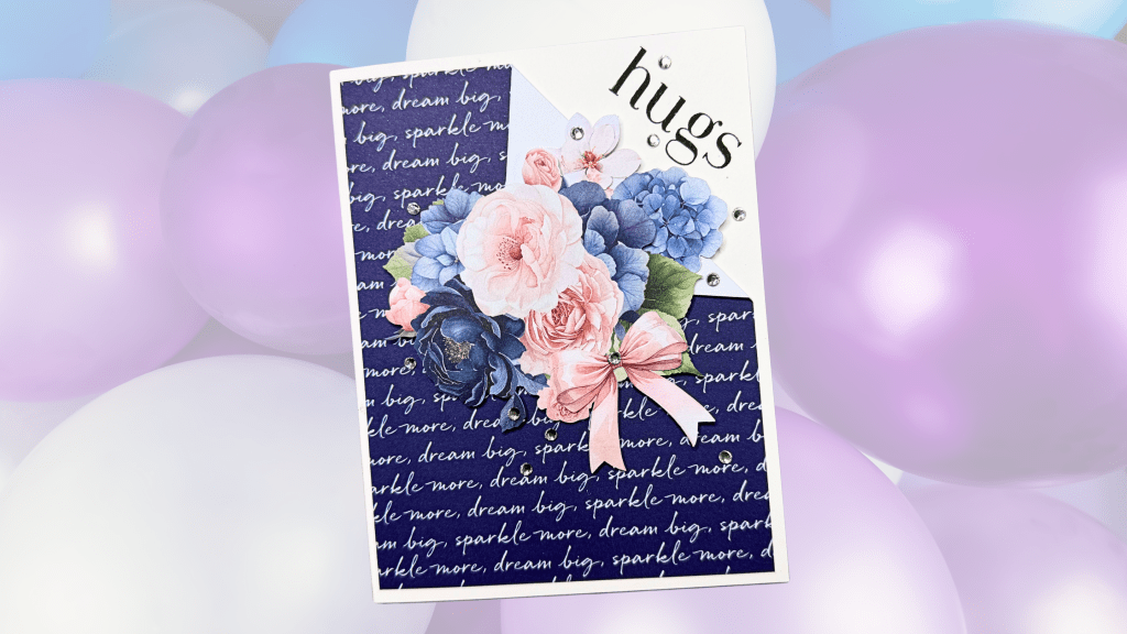 A handmade card featuring a floral arrangement and the word 'hugs' on a patterned background, with pastel balloons in soft colors in the background.