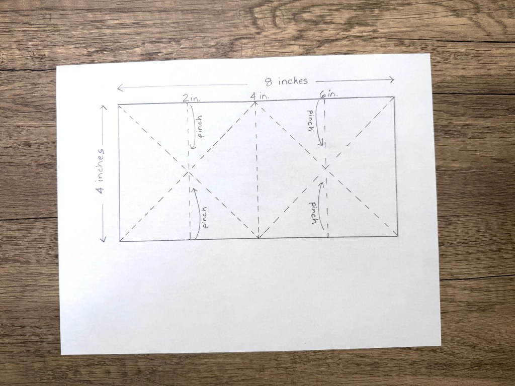 Diagram showing measurements and folding lines for creating an explosion card mechanism, with dimensions labeled: 8 inches wide by 4 inches tall, including pinch points marked at 2 inches, 4 inches, and 6 inches.