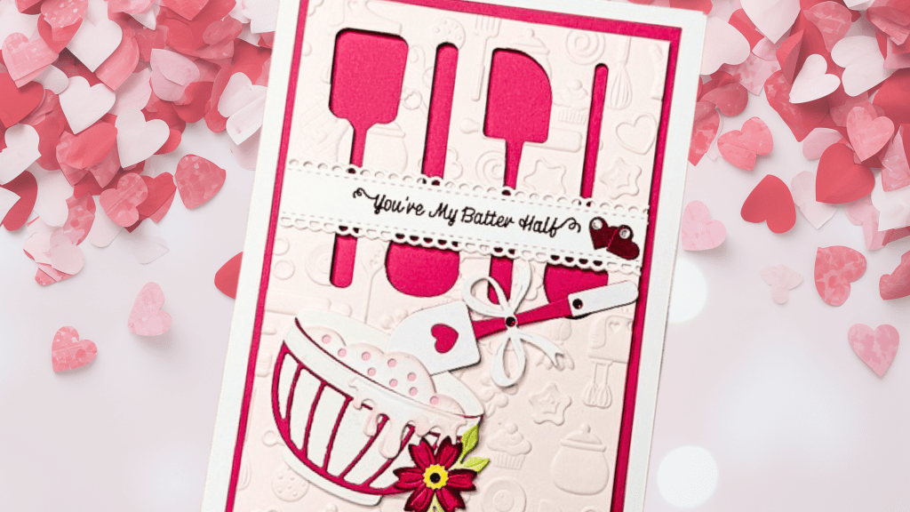 A handmade card featuring baking utensils like a whisk and spatula, with a decorative bowl and the phrase 'You're My Batter Half.' The card has a pink and white color scheme, surrounded by heart-shaped confetti.