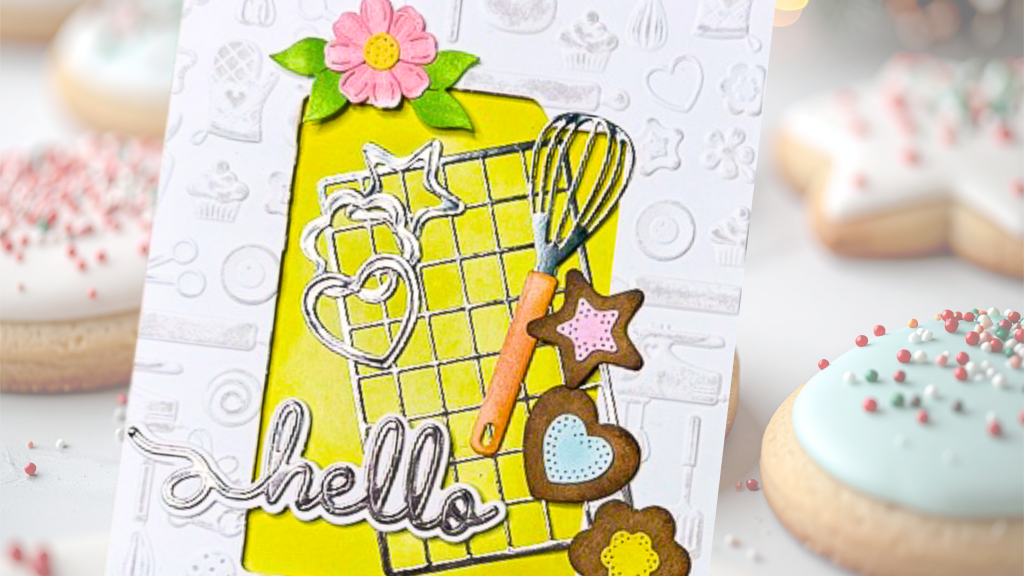 A colorful greeting card featuring a whisk, cookie shapes, and the word 'hello' on a yellow background, with decorated cookies in the background.