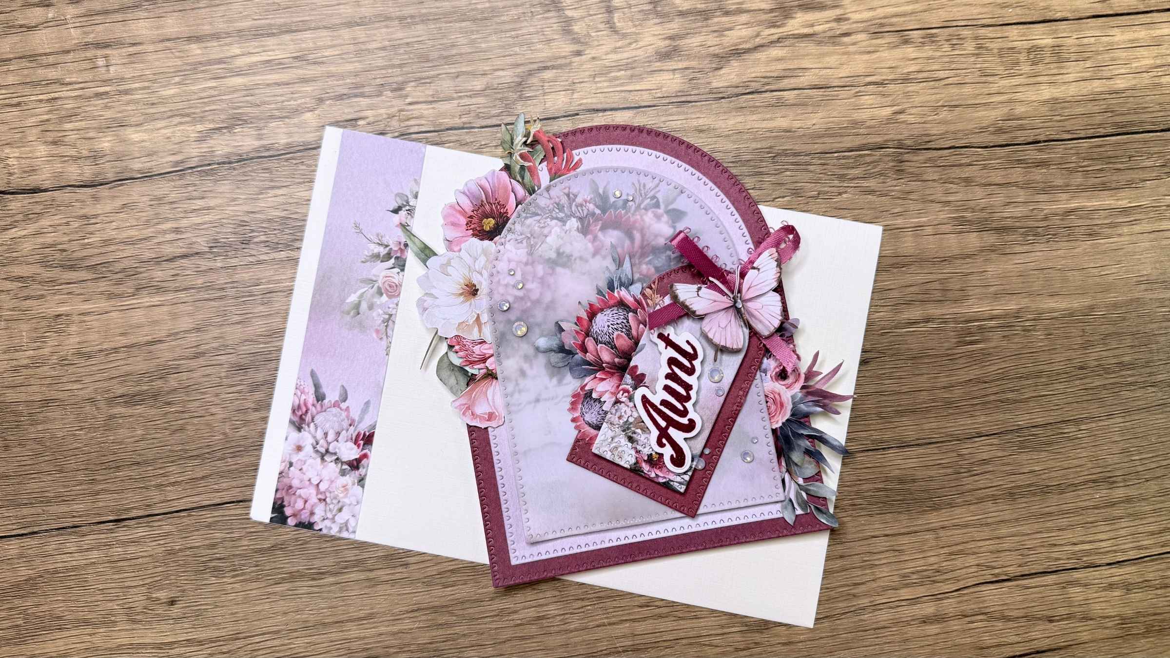 1 Purple floral arch-shaped greeting card with butterfly embellishment and the word Aunt with a matching envelope