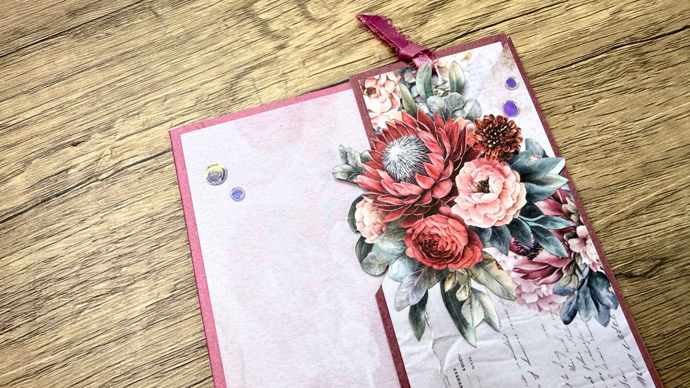 5 Handmade greeting card with detailed paper flowers and leaves on a wooden surface