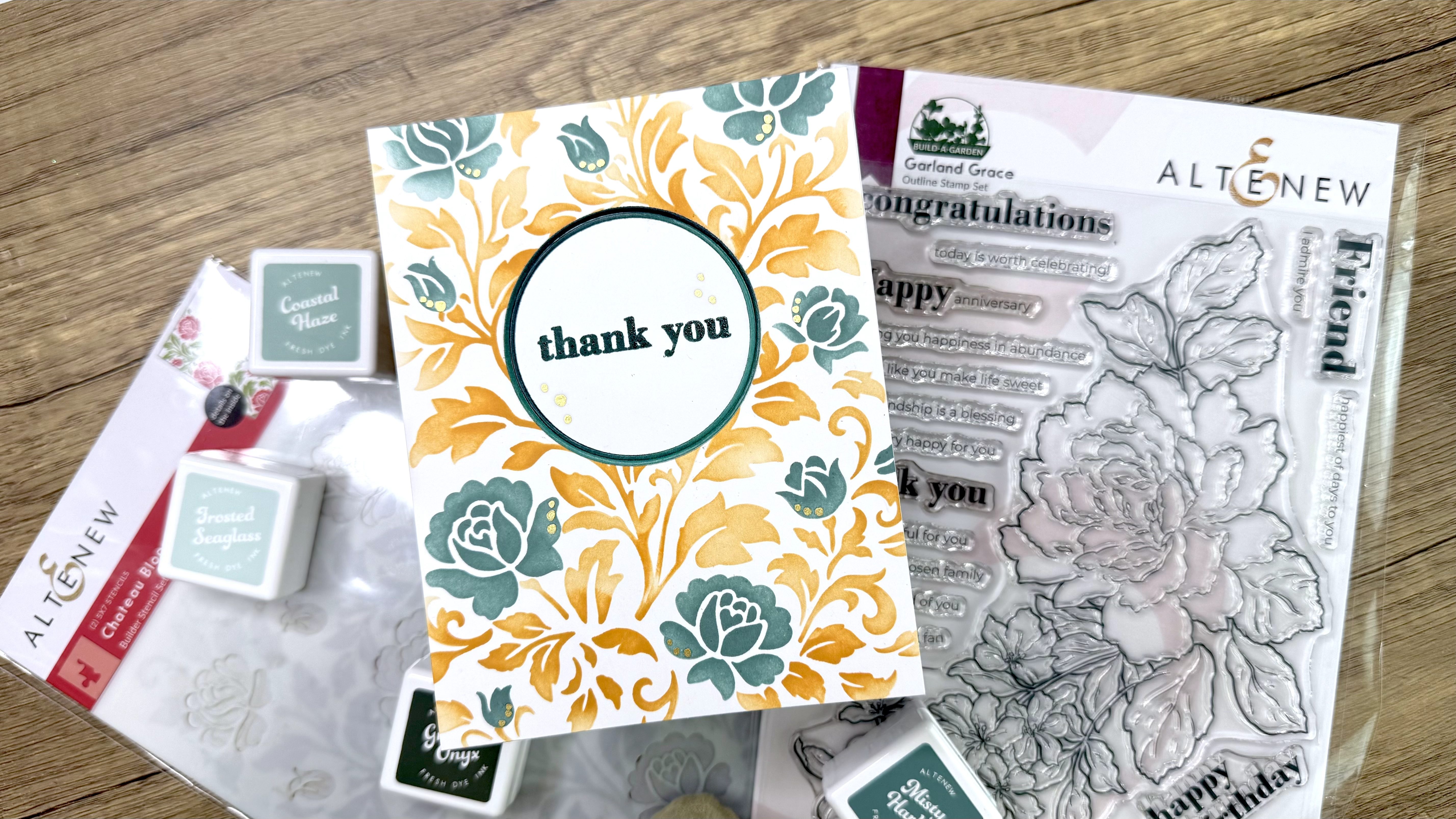 IMG_2402 Handmade thank you card with orange and teal floral design surrounded by stamping inks and clear stamp set