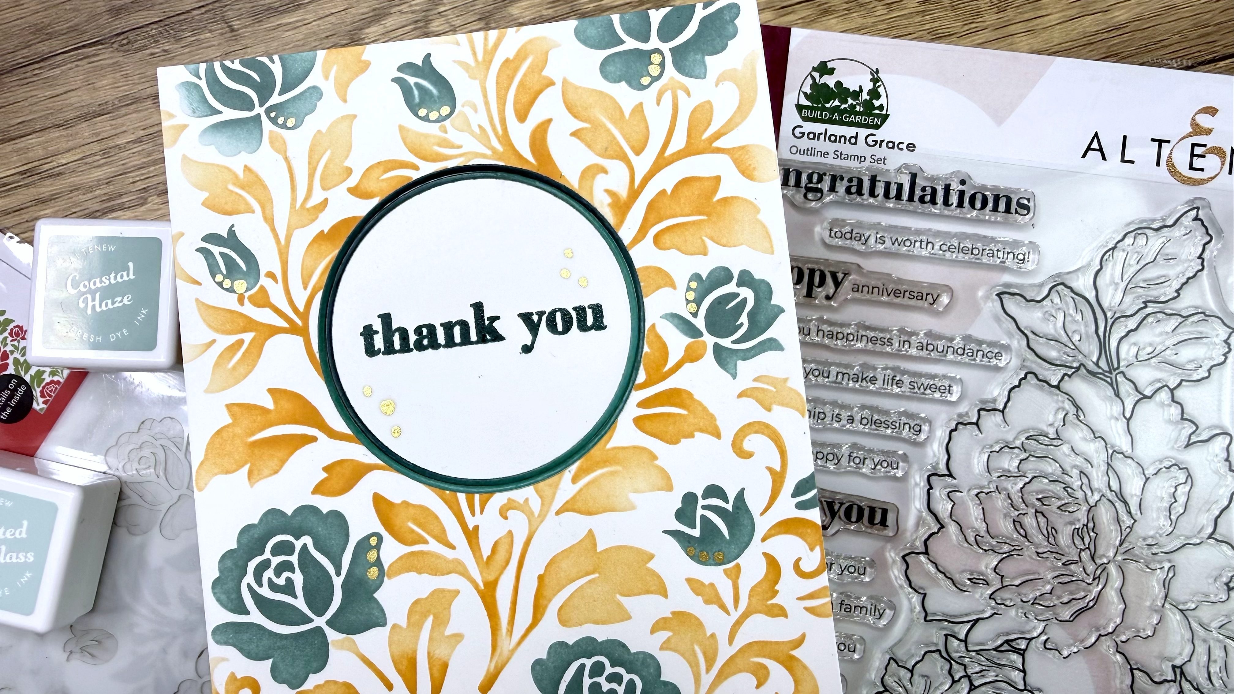 IMG_2403 Handmade thank you card with orange and teal floral design surrounded by stamping inks and clear stamp set