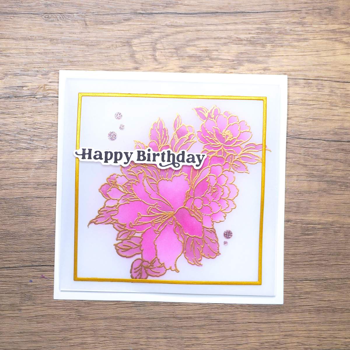 HandmadeCardsByToni-Vellum-Overlay-Card-1 Birthday card with pink floral design outlined in gold and text Happy Birthday