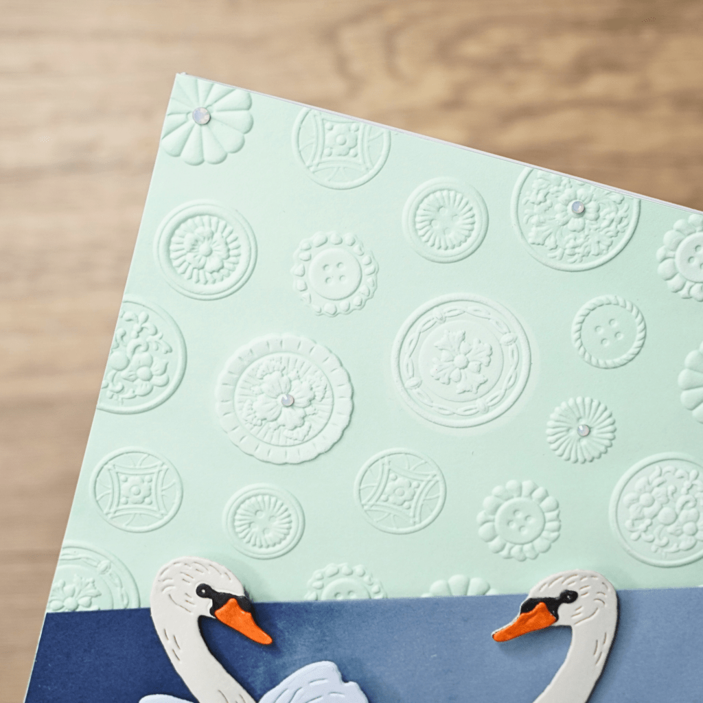 Embossed floral cardstock background used for an elegant handmade card design.