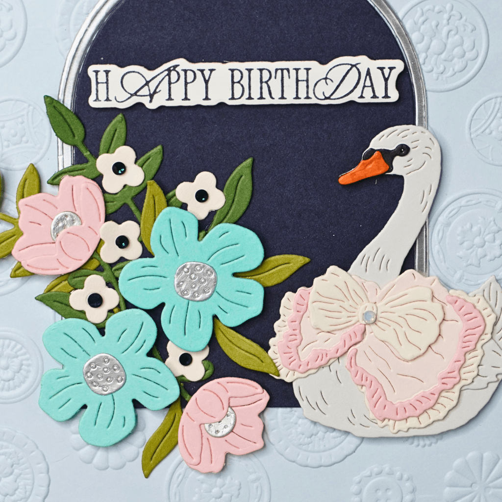 Close-up of layered die-cut swan with dimensional details.