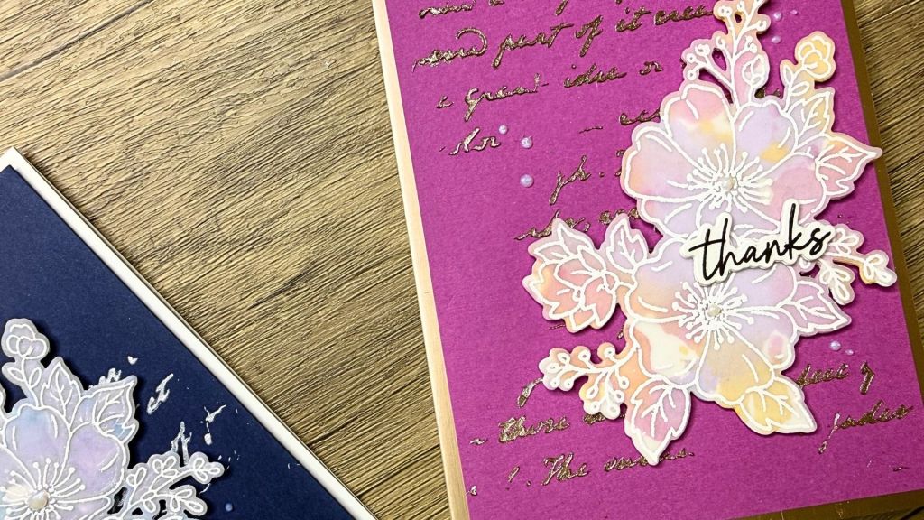 purple handmade thank you card with watercolour and vellum floral designs on a wooden surface