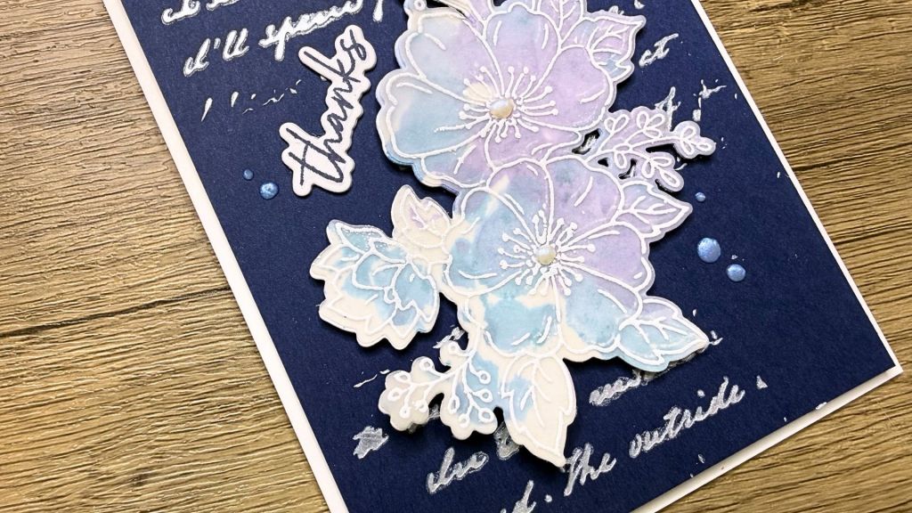 navy and white handmade thank you card with watercolour and vellum floral designs on a wooden surface 